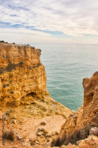 Ledge with birds between two cliffs in southern Portugal on the Seven Hanging Valleys Trail on a winter day next to the ocean.