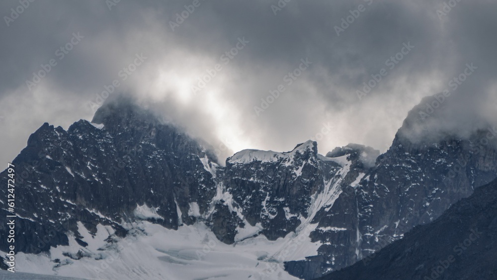 Snowy peak with stormy cloudy sky in Mistaya Canyon, Banff town, Canada