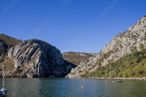 Beautiful landscape of a lake near green hills on a sunny day