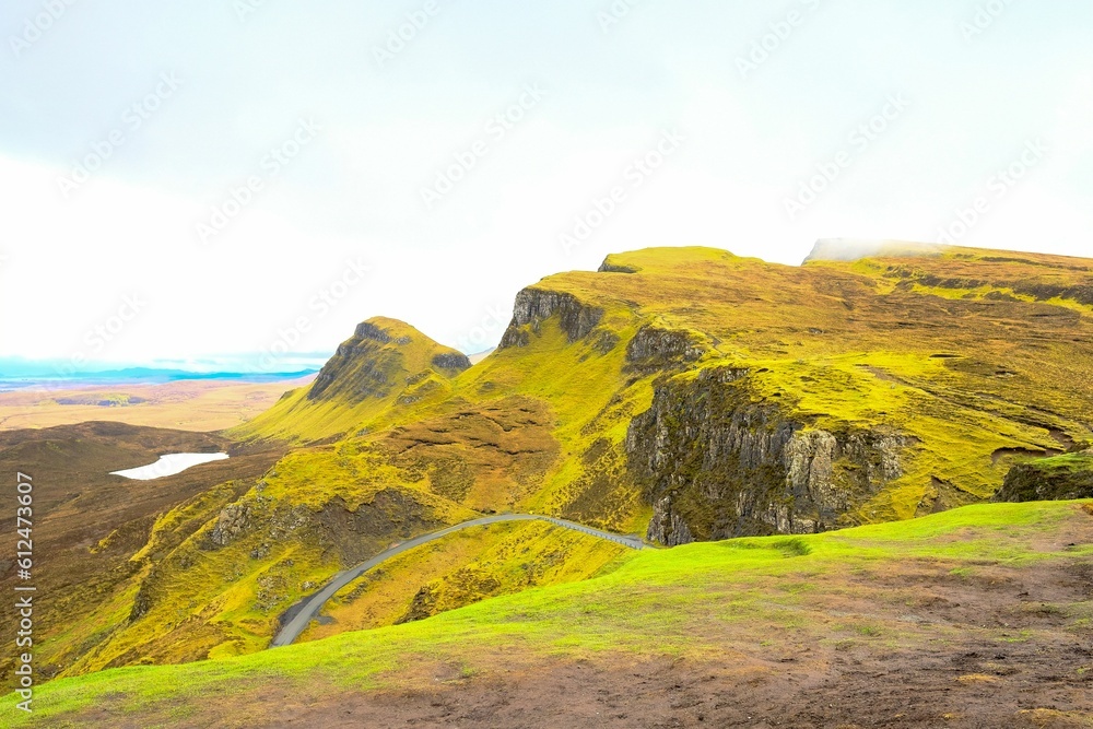 Mountain hill with a mountain trail for transportation against a bright sky in Scotland