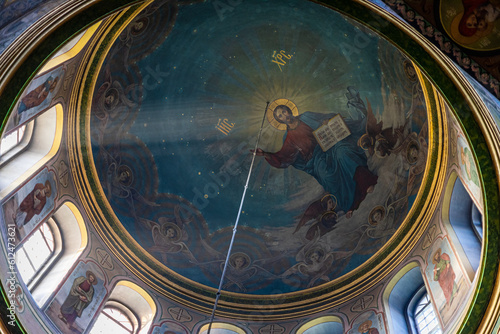 Beautiful dome in an orthodox cathedral  church. Beautiful Christian murals. The sun s rays illuminate the dome beautifully. Beautiful mural with Jesus Christ. Apostles and icons.