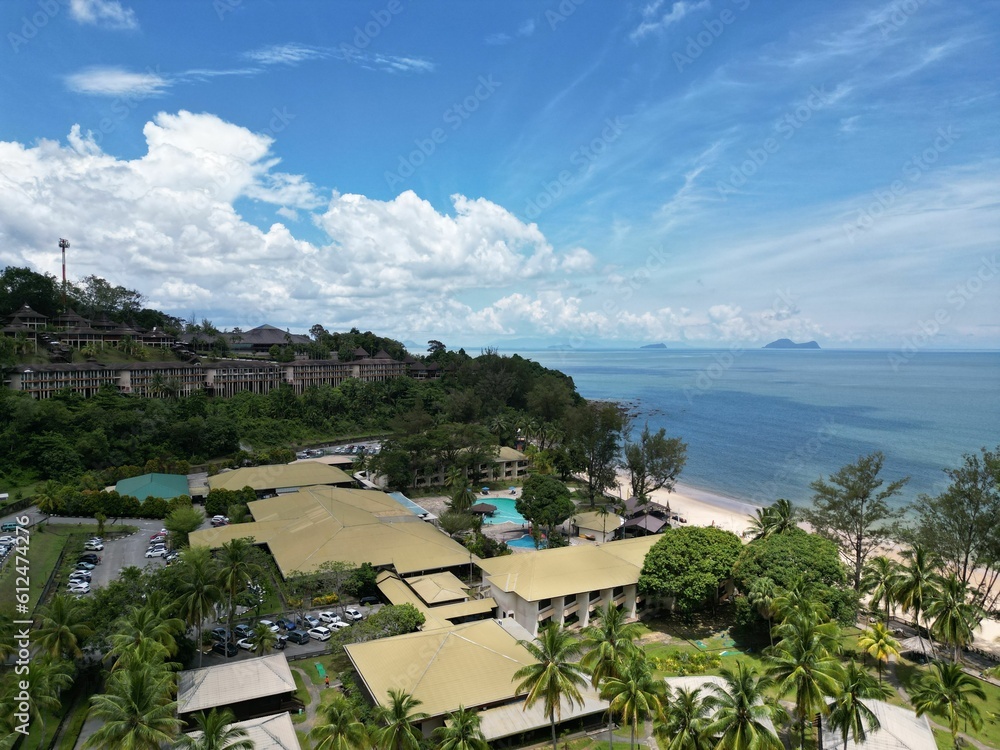 Aerial view of the ocean surrounded by beautiful greenery and resorts in Sarawak