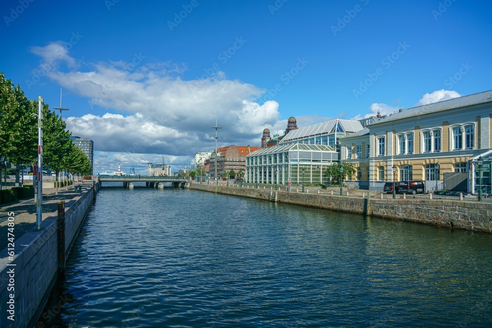 Canal with buildings and a bridge in the background in Malmo, Sweden