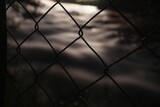 Closeup shot of a mesh fence with blurred background