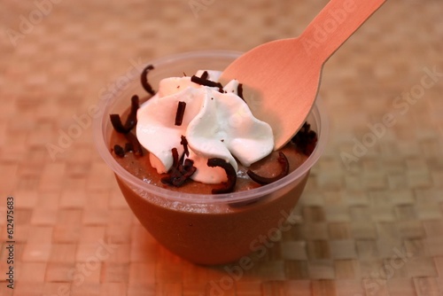 Closeup of delicious silky smooth chocolate mousse decorated with whipping cream