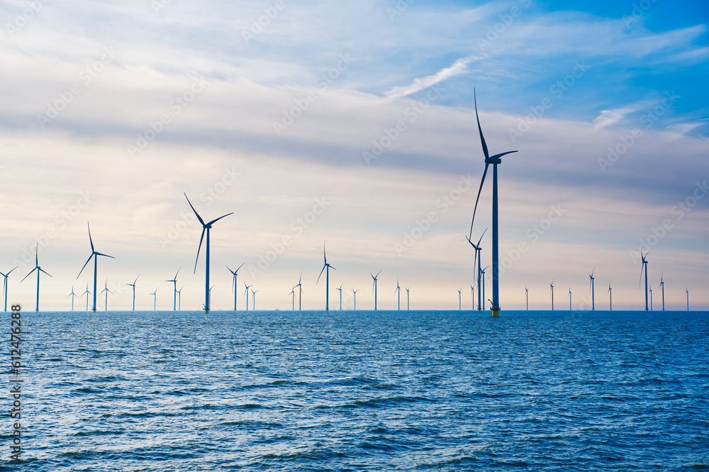 Offshore Windmill farm. windmills isolated at sea on a beautiful bright day Netherlands. green energy Flevoland global warming renewable enrgy with windmills