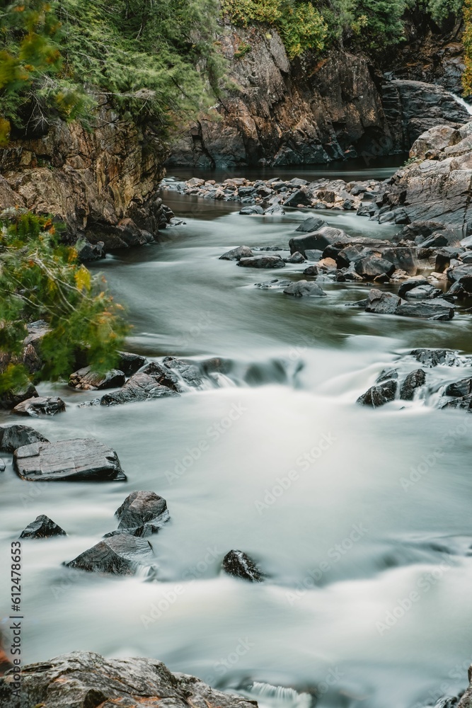 Scenic view of a water cascade in long exposure effect flowing on rocks Scenic view of a water cascade in long exposure effect flowing on rocks
