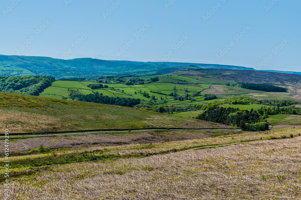 A view from the path leading down from the Stanage Edge escarpment across the valley below in the Peak District, UK in summertime