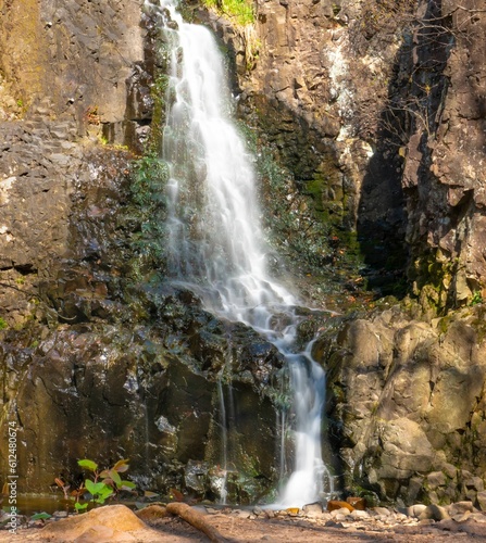 Vertical shot of a splashing cascading waterfall in the mountains