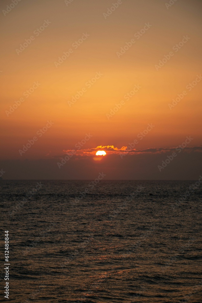 Vertical shot of a beautiful sunset over the Adriatic sea on an Italian shore
