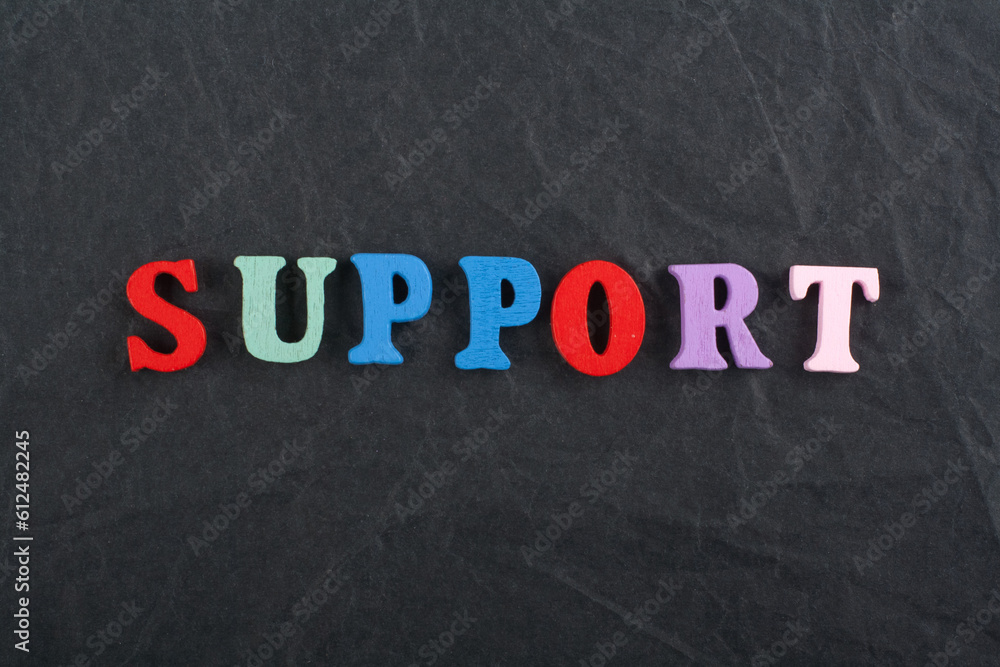 SUPPORT word on black board background composed from colorful abc alphabet block wooden letters, copy space for ad text. Learning english concept. SUPPORT word on black board background composed from colorful abc alphabet block wooden letters, copy space for ad text. Learning english concept.