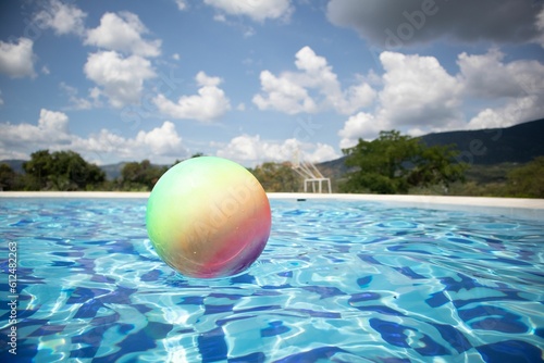 Closeup shot of a colorful pool ball on the water on a sunny day