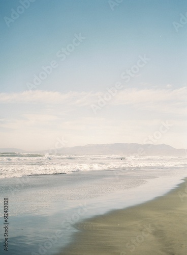 Beautiful shot of waves washing up the sandy beach