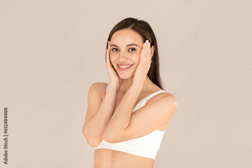 Cute young caucasian woman in underwear touching her face Cute young caucasian woman in underwear touching her face
