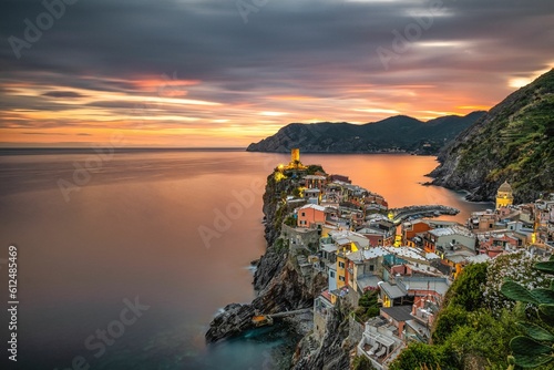 Picturesque view of a sunset over the colorful residential buildings in Vernazza