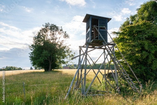 Beautiful shot of a wooden hunting watch tower in a field © Dimitry Anikin/Wirestock Creators
