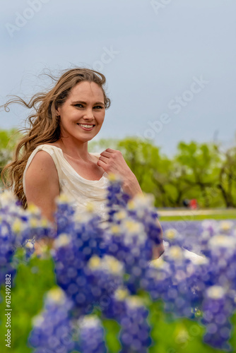 A Lovely Brunette Model Poses In A Field Of Bluebonnet Flowers In A Texas Prarie