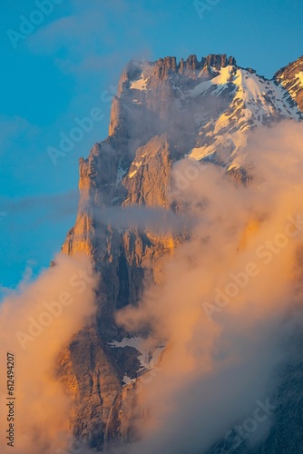 Large mountain covered in snow and clouds