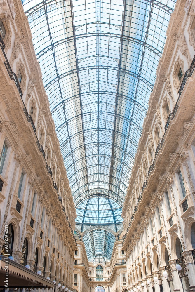 Beautiful low angle view of the arched glass roof and intricate columns in a shopping mall in Milan