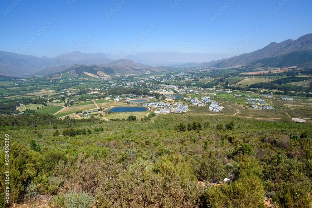Scenic view of a town at a valley and the surrounding mountains
