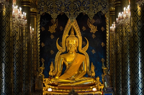 Sitting golden Buddha inside an imposing Buddhist temple