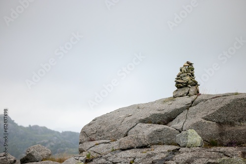 Stack of rocks standing in balance on top of a cliff, the concept of zen philosophy © Odd Bjarne Brekke/Wirestock Creators
