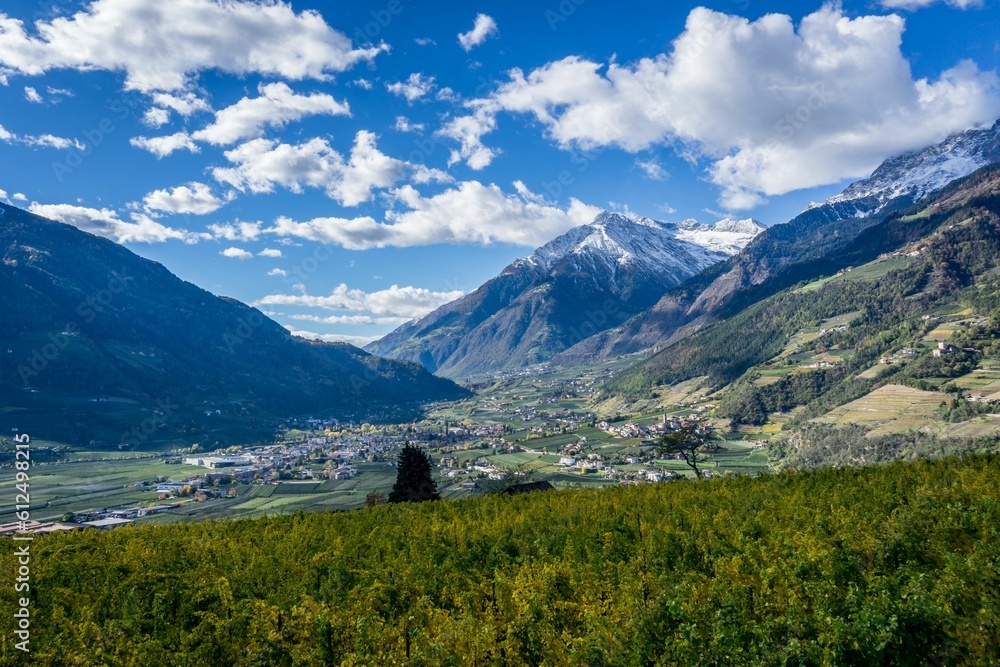 Natural view of greenfield, village, and mountain landscape in the countryside of South Tyrol, Italy