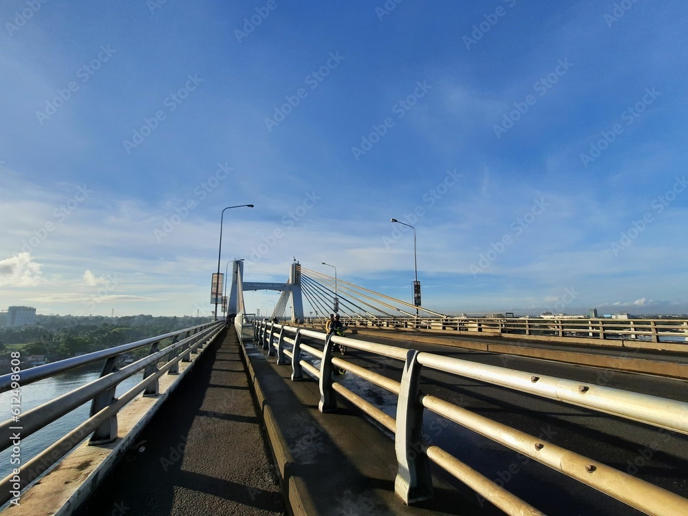 View of a long bridge over the calm river water