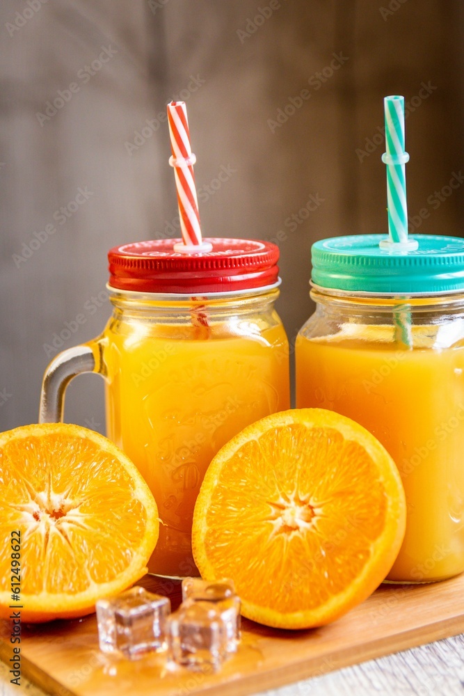 Mason jar with orange lemonade on the table, close-up Mason jar with orange lemonade on the table, close-up