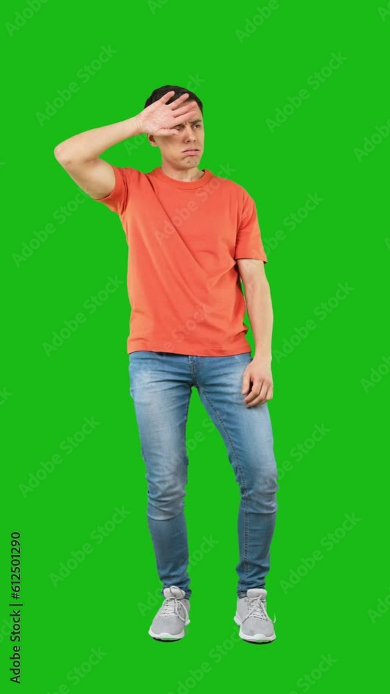 Exhausted man looking at camera. Green background Exhausted man looking at camera. Green background