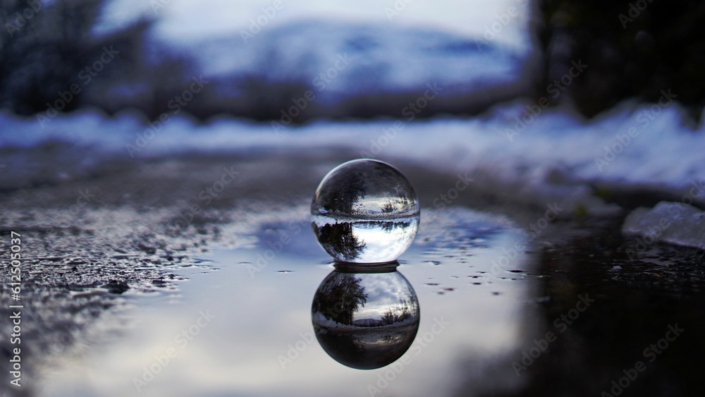 Crystal glass ball on wet ground Crystal glass ball on wet ground