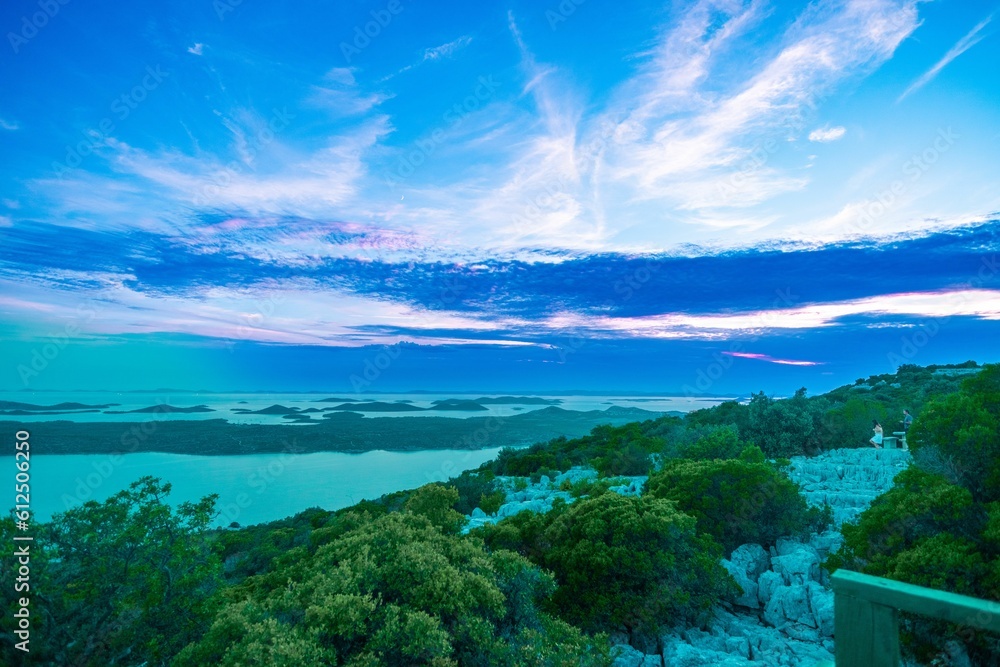 Beautiful scene of Sea view with trees in Croatia under orange sky Beautiful scene of Sea view with trees in Croatia under orange sky