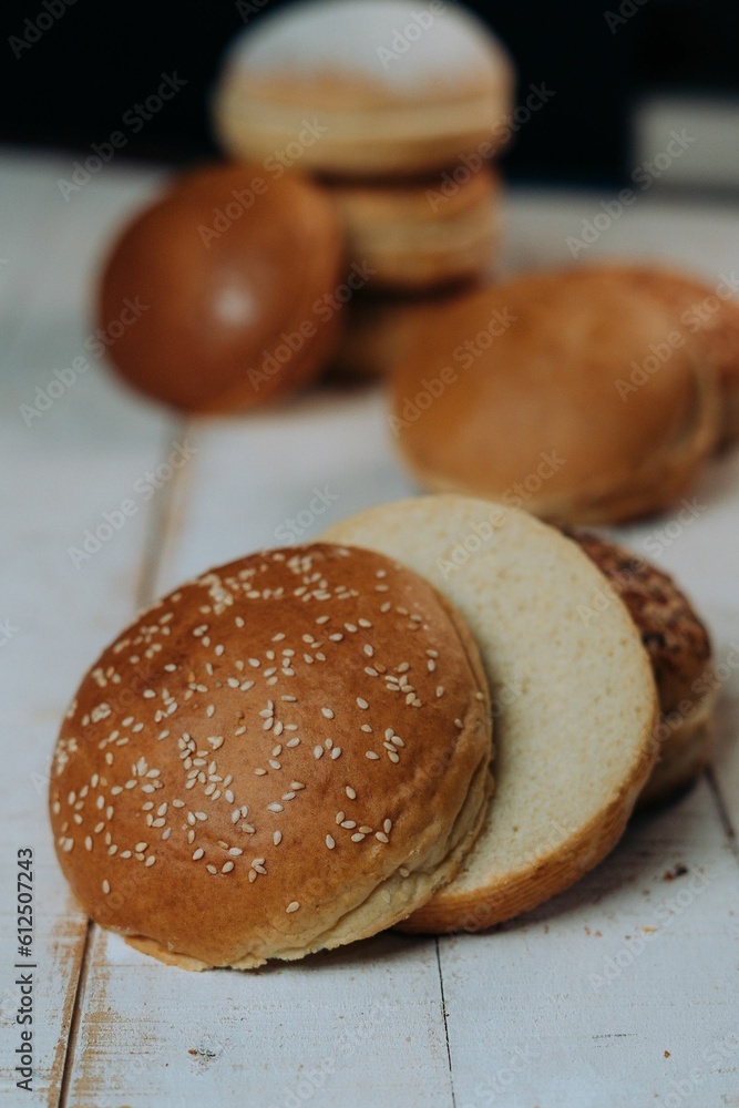Vertical of the freshly baked and sliced bun breads put on the white table surface