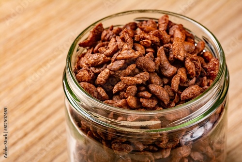 Jar of chocolate cereal on a wooden surface