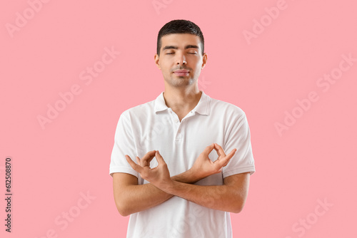 Young man meditating with e...