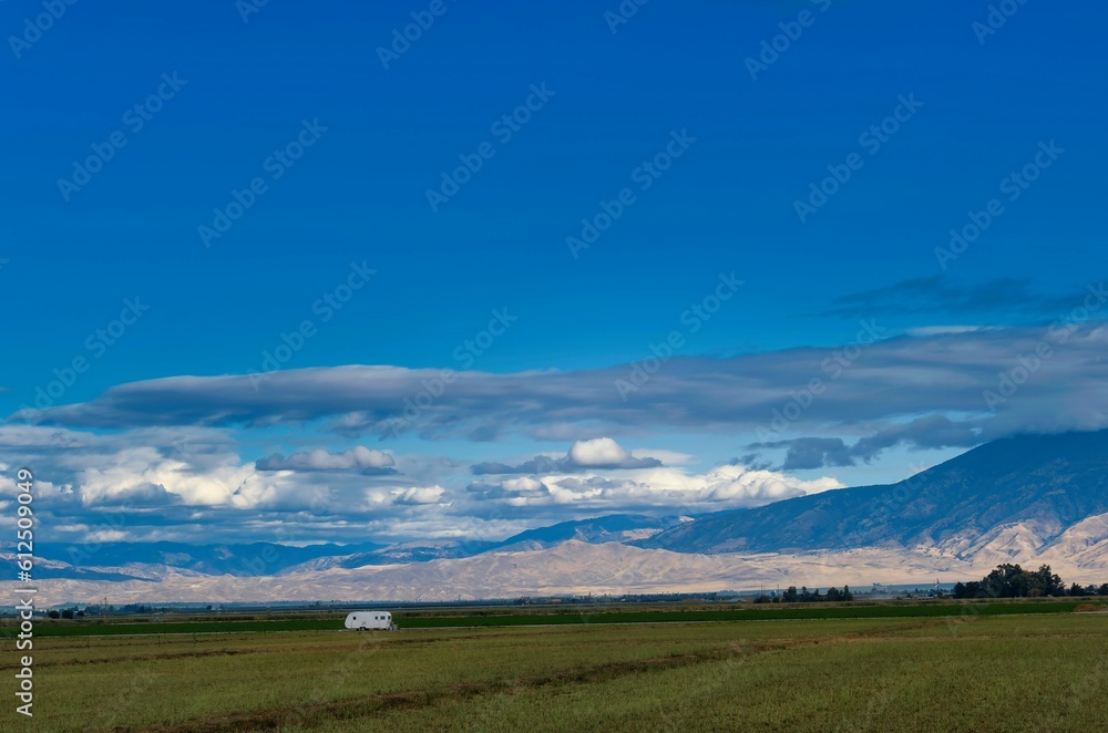 Trailer in the field with Sierra Nevada in the background in California, Central Valley