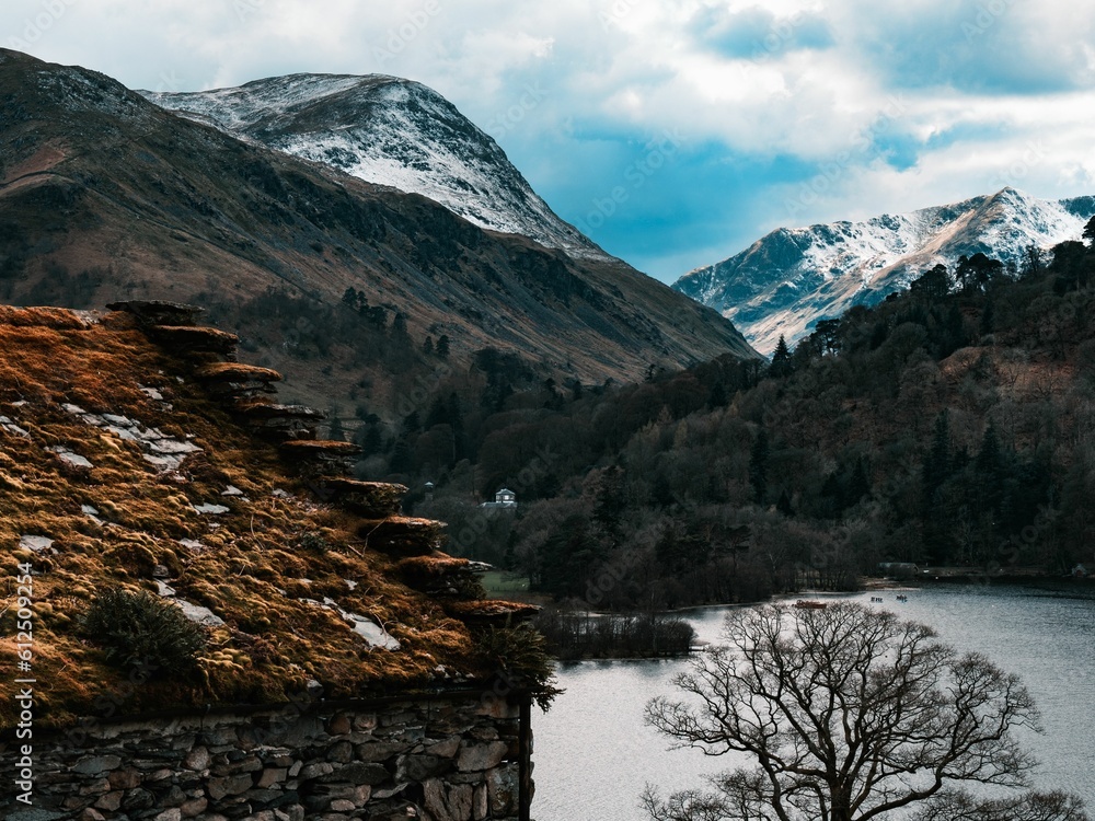 Landscape view of the Ullswater lake district in England with snow-covered mountains in the back