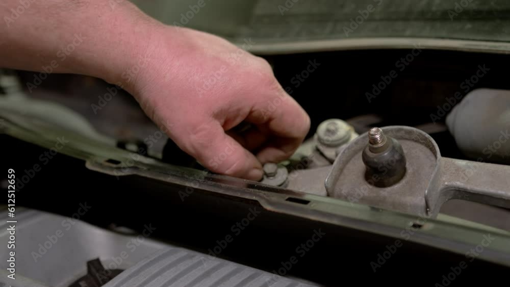 Car mechanic replacing car at repair service station Car mechanic replacing car at repair service station