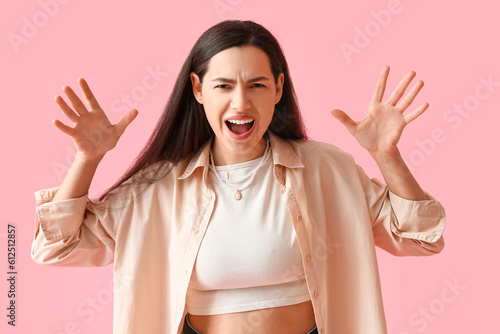 Angry young woman in shirt ...