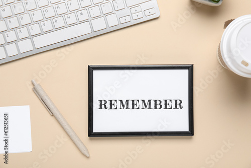 Reminder with computer keyboard on beige background