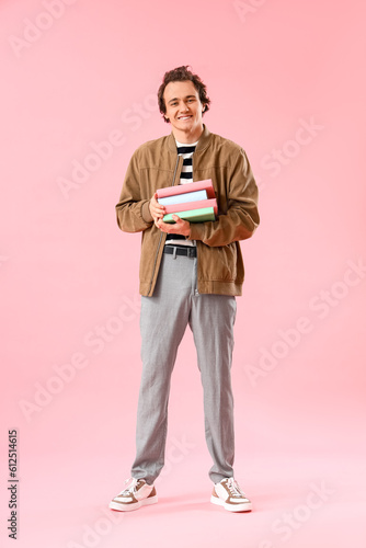 Young man with stack of boo...