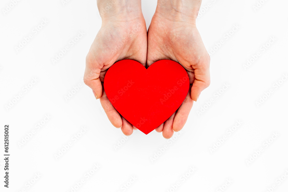 Woman holding red heart in hands. Medical insurance or health care concept Woman holding red heart in hands. Medical insurance or health care concept