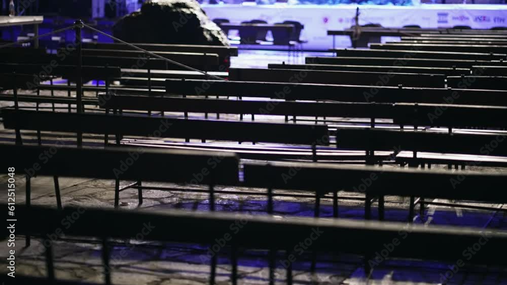 Rows of old empty wooden benches in an outdoor theatre Rows of old empty wooden benches in an outdoor theatre