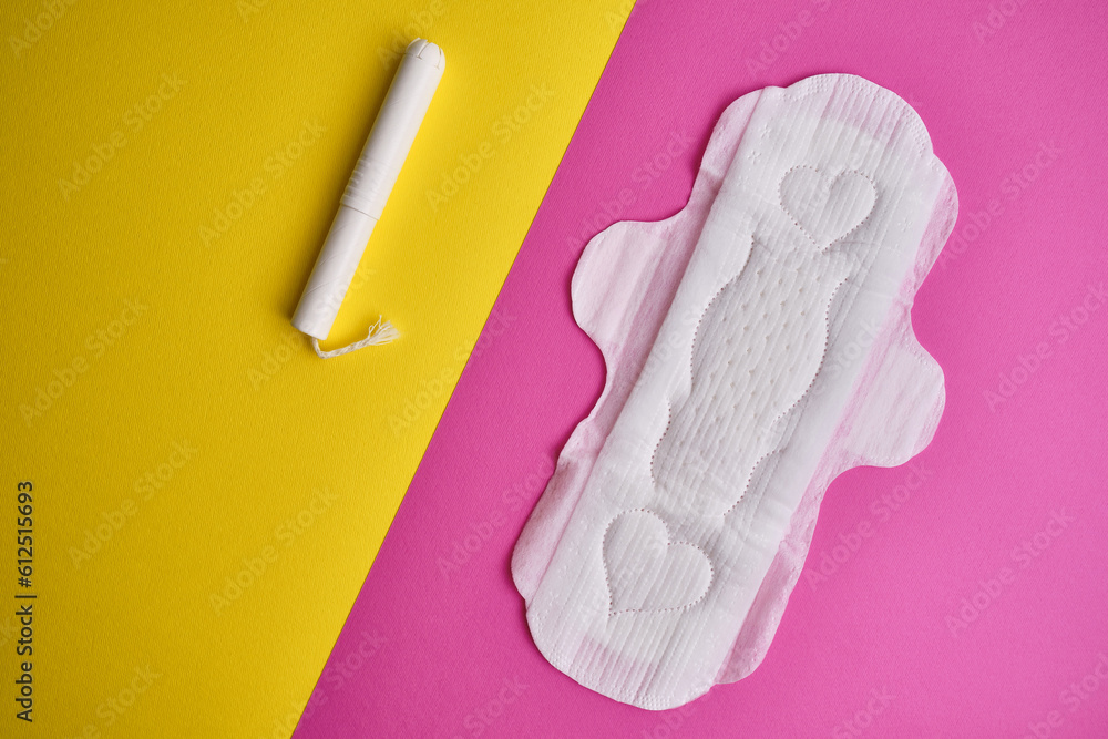 Women's pads and tampon. Sanitary pads lie next to a tampon on an