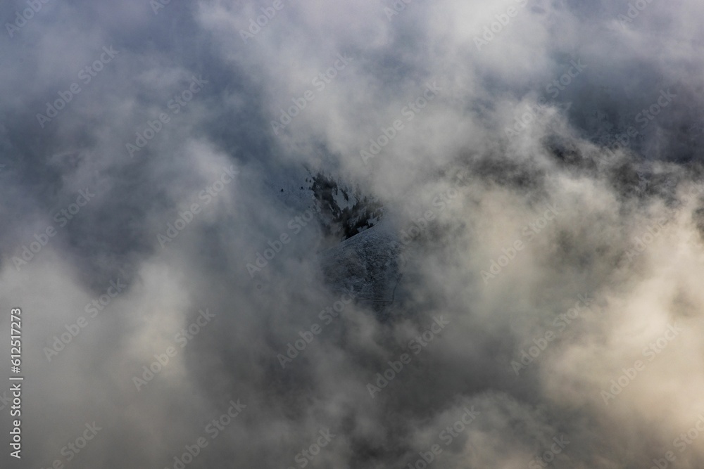 Dramatic ambiance of white clouds over the Gantrisch Mountain in Swiss Alps
