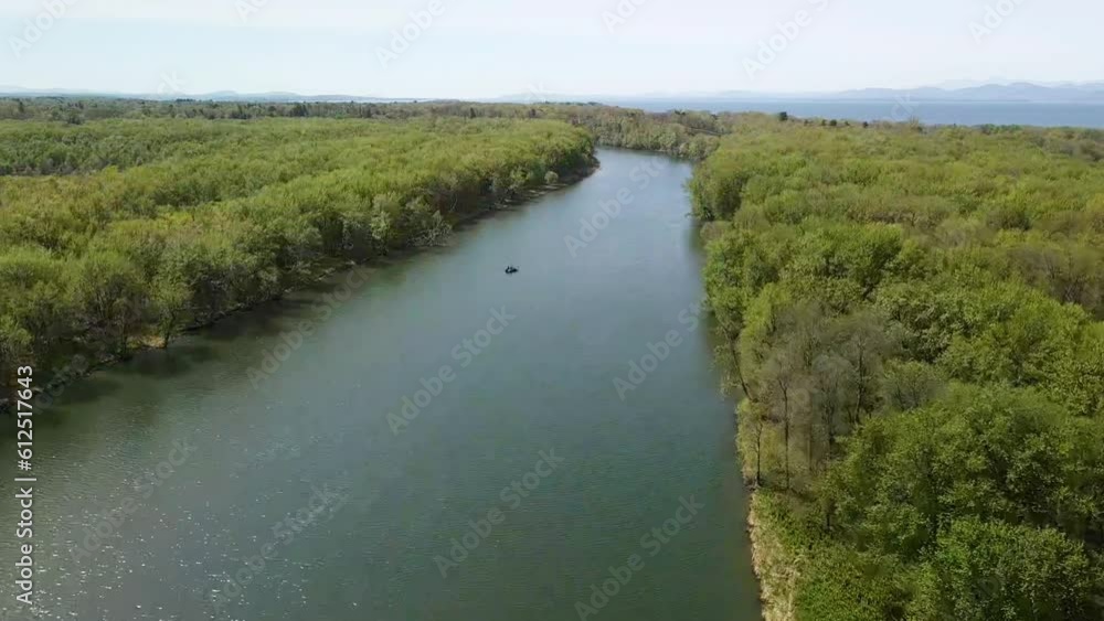 Scenic view of the beautiful tranquil Winooski River surrounded by evergreen trees in Vermont Scenic view of the beautiful tranquil Winooski River surrounded by evergreen trees in Vermont