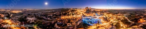 Panoramic shot of Goreme at night illuminated by night lights at dusk, Turkey