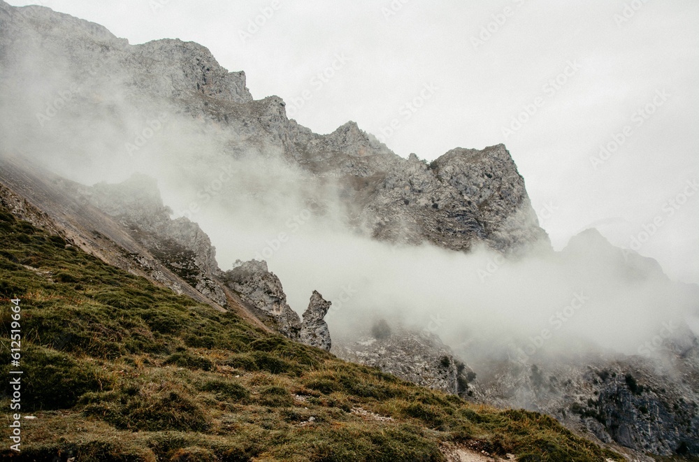 Low angle shot of the foggy mountains in The Cares Trail, Picos de Europa, Asturias, Spain