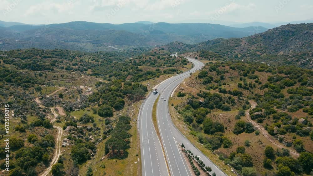 Motorway highway vehicles pass scenic mountain landscape, aerial view Motorway highway vehicles pass scenic mountain landscape, aerial view
