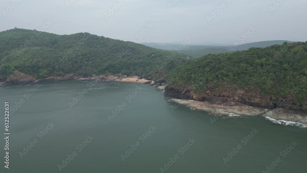 Aerial video of the rocky mountains covered with trees on the sea shore, gokarna, karnataka, India Aerial video of the rocky mountains covered with trees on the sea shore, gokarna, karnataka, India